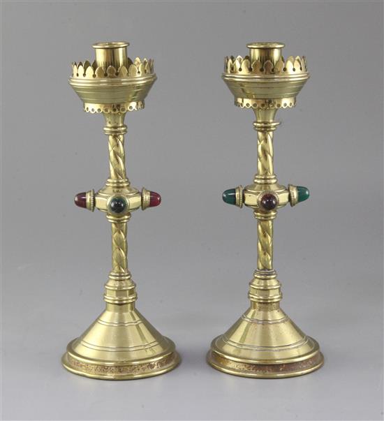 A pair of Gothic revival brass candlesticks, height 10in.